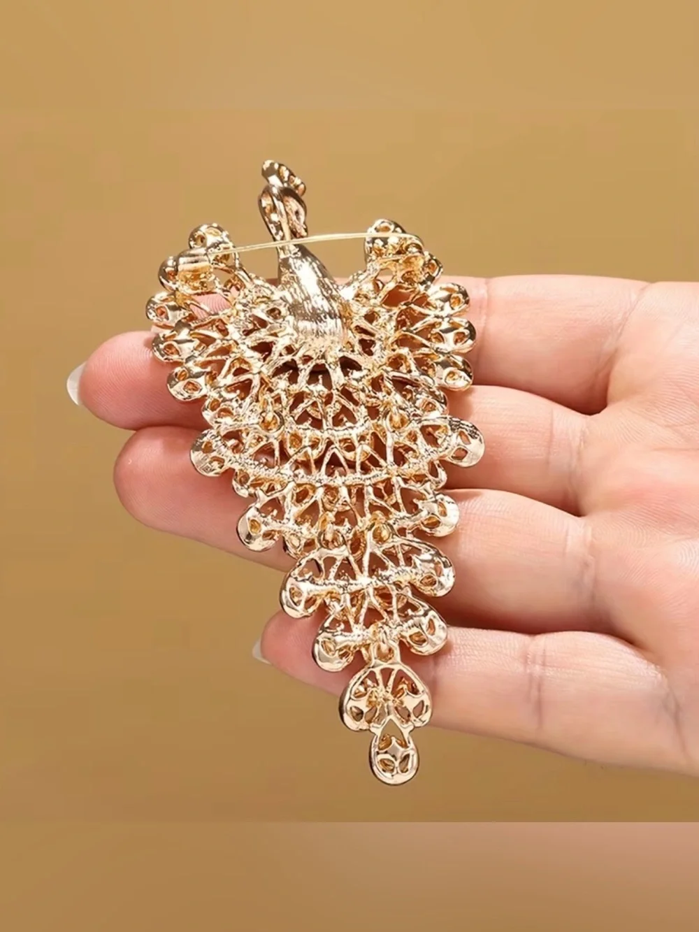 sparkling peacock-shaped statement brooch featuring blue crystals silver-tone